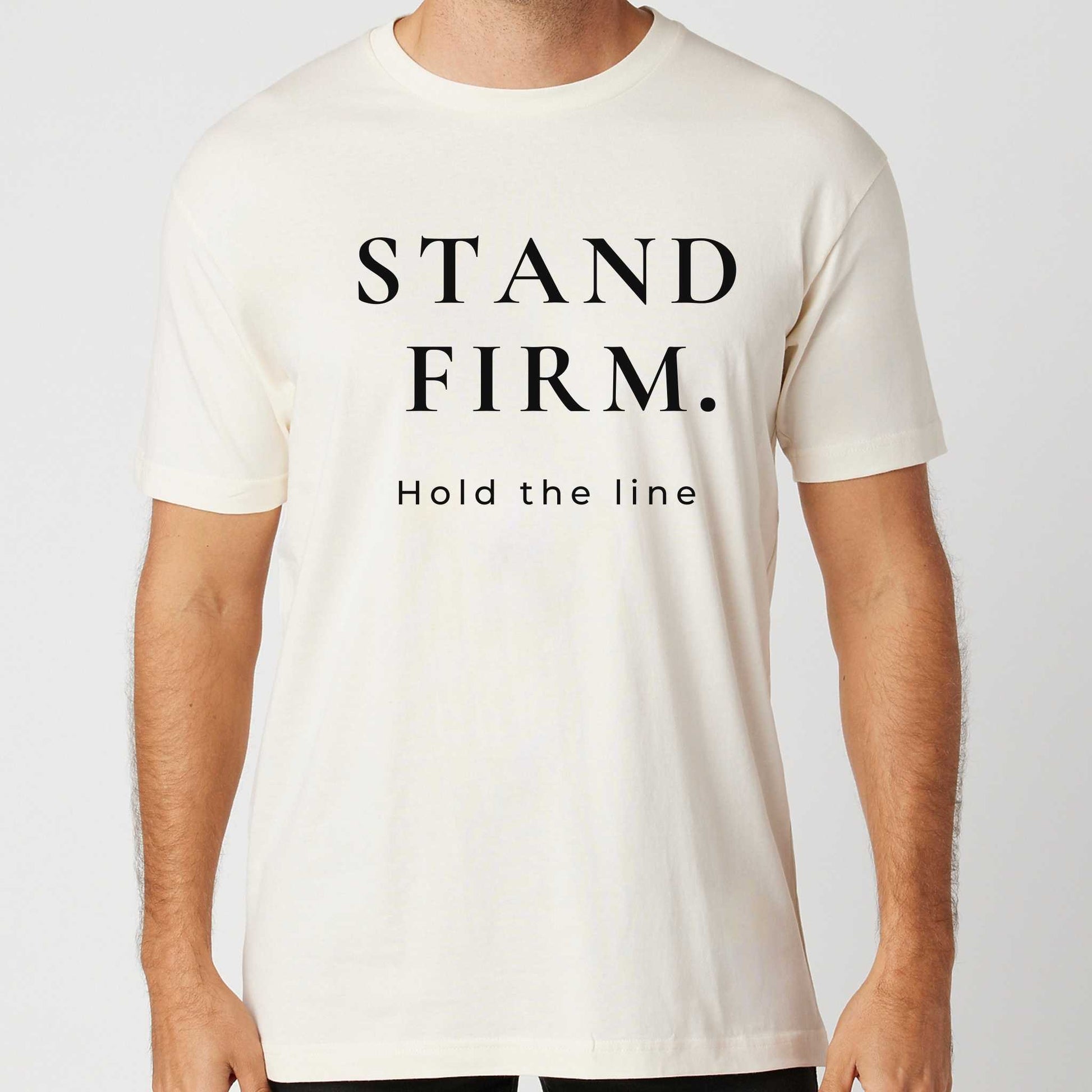 Person wearing a vintage white t-shirt with 'STAND FIRM. Hold the line' text on a plain background