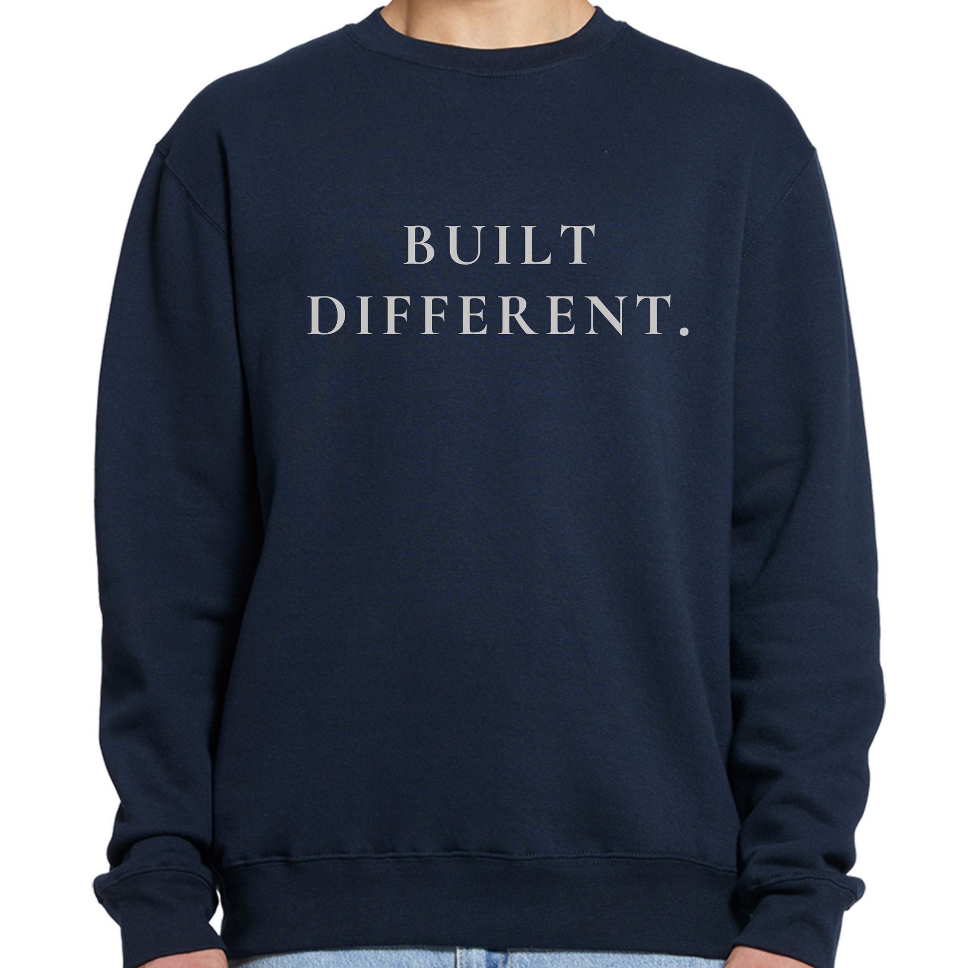 Navy blue crewneck sweatshirt with 'BUILT DIFFERENT.' text on a white background